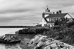 Nayatt Point Lighthouse Along Rocky Shore BW